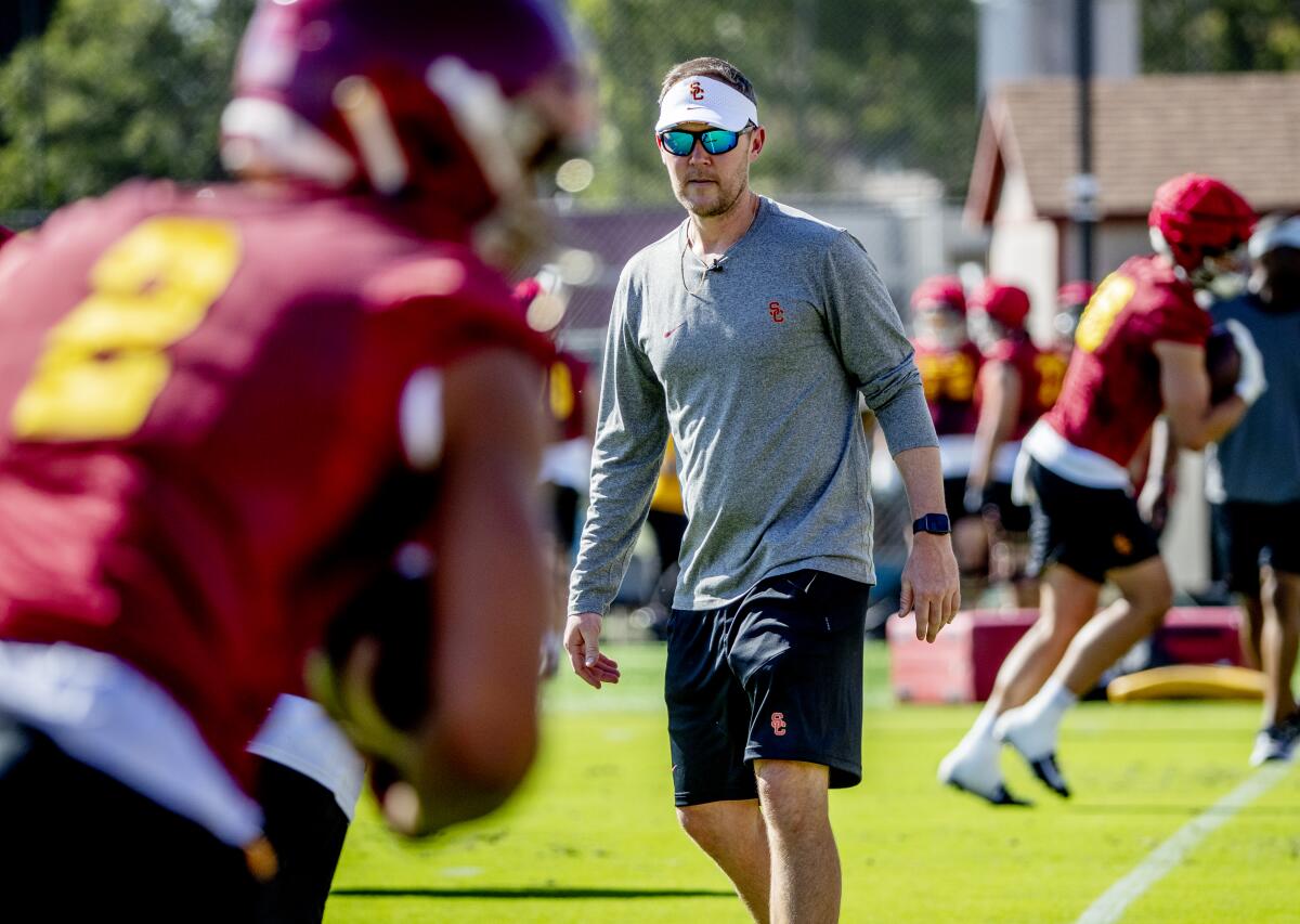 USC football coach Lincoln Riley watches his players during a practice session in March.