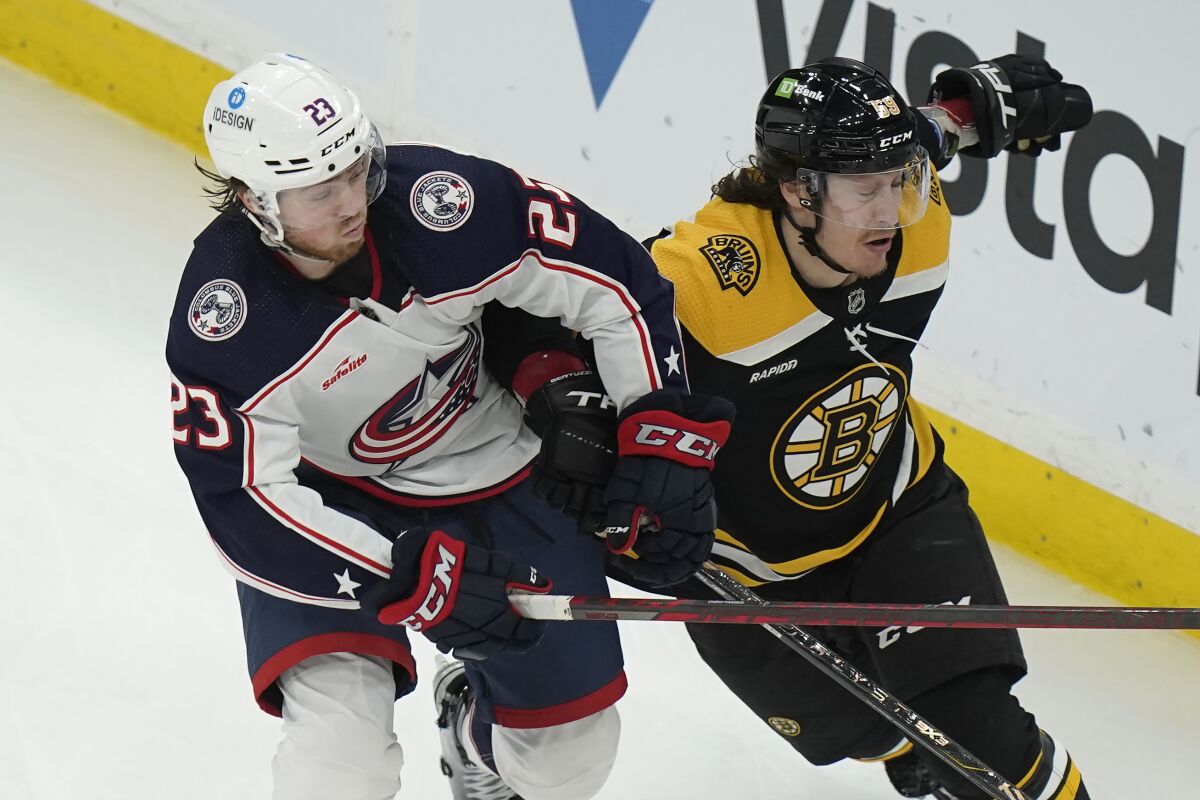 Columbus Blue Jackets defenseman Jake Christiansen (23) collides with Boston Bruins left wing Tyler Bertuzzi (59) in the third period of an NHL hockey game, Thursday, March 30, 2023, in Boston. (AP Photo/Steven Senne)