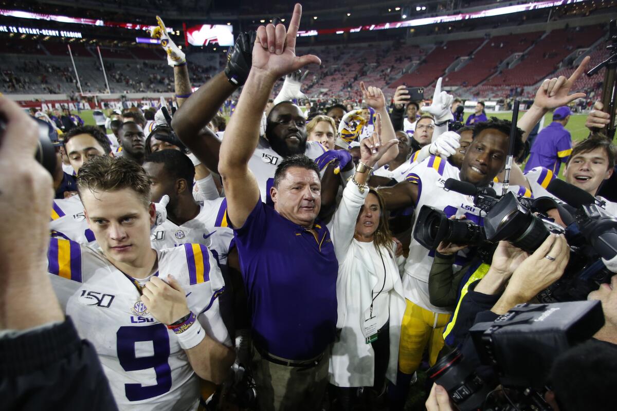 LSU coach Ed Orgeron celebrates with his players after defeating Alabama 46-41 on Saturday.
