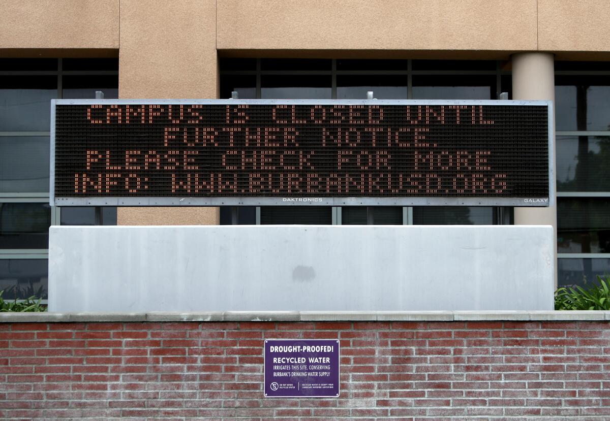 Burroughs High School is closed until further notice, according to an electronic board at the school in Burbank on Wednesday, April 8, 2020.
