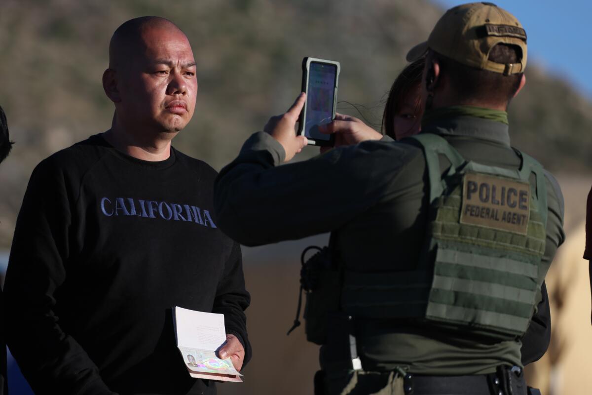 Jacumba Hot Springs, CA, Sunday, May 12, 2024 - Chinese migrant Zhen Jiang is photographed by a