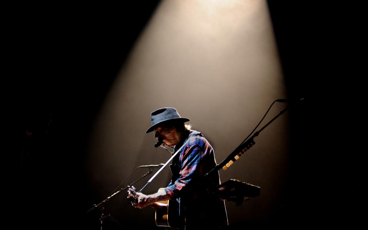 Rock and Roll Hall of Fame member Neil Young performs at the Forum duing his Rebel Content tour in Inglewood Wednesday.