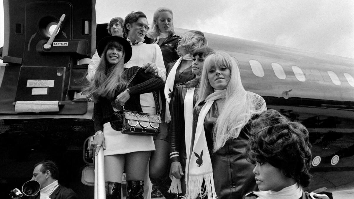 Playboy Magazine publisher Hugh Hefner, top center, his girlfriend actress Barbara Benton, left, and film director Roman Polanski, top left, arriving at Le Bourget airport in France in 1970.