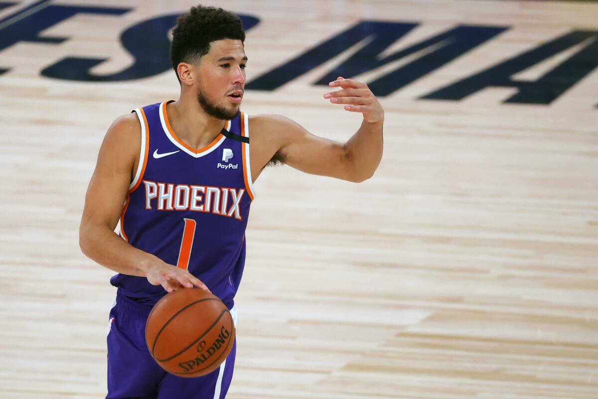 Phoenix Suns guard Devin Booker directs his teammates during a win over the Clippers on Aug. 4, 2020.