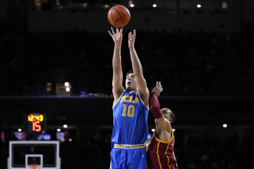 UCLA guard Lazar Stefanovic shoots over USC guard Kobe Johnson on Saturday