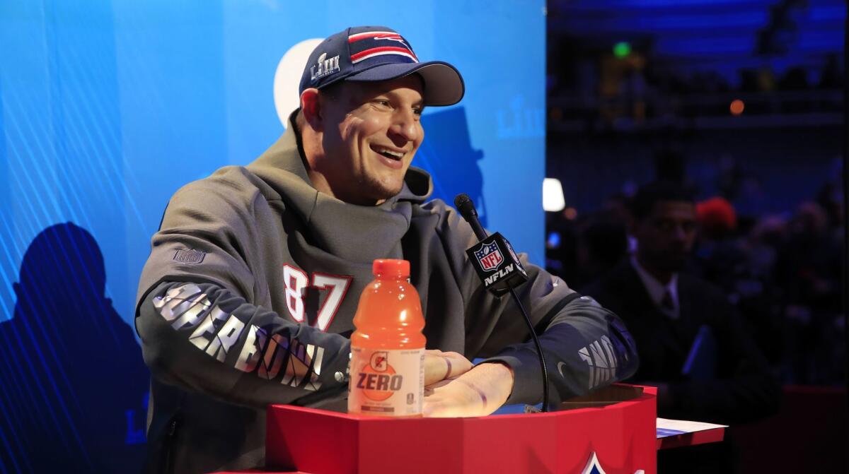 New England Patriots tight end Rob Gronkowski fields media questions during a Super Bowl event at State Farm Arena in Atlanta.