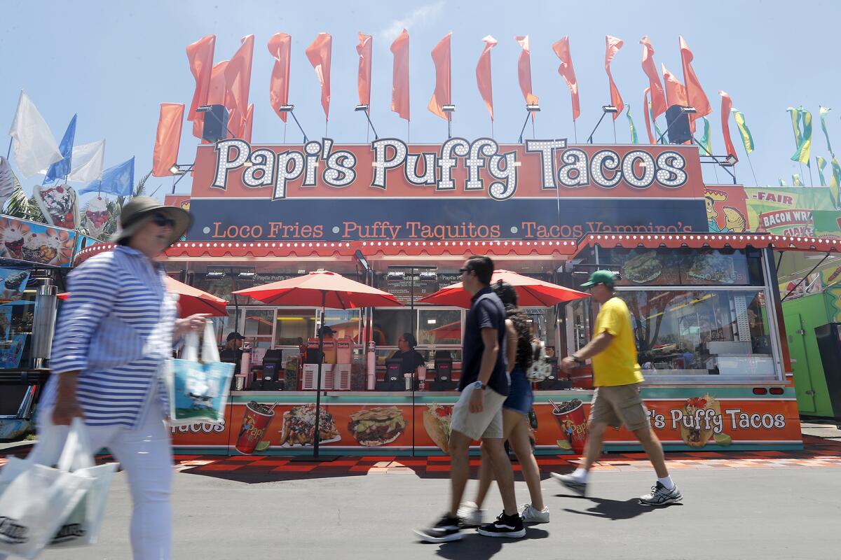 To find Papi's Puffy Tacos at the Orange County Fair, look for its orange-colored stand.