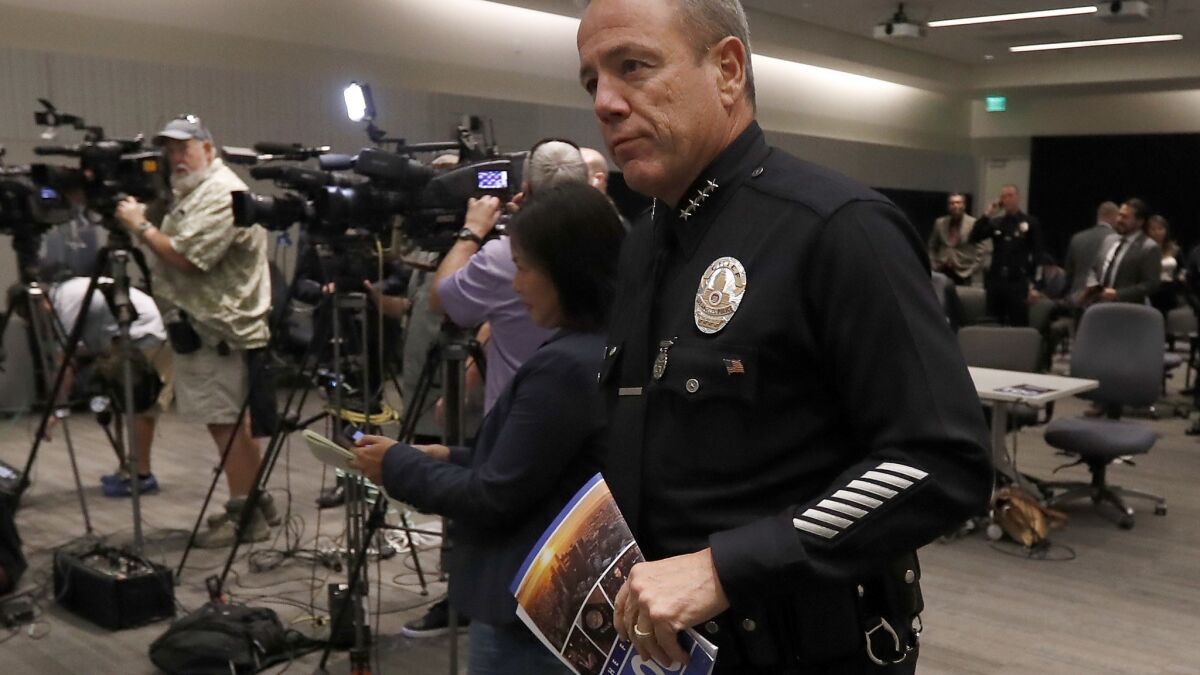 LAPD Chief Michel Moore arrives for a news conference about his first 100 days as the city's top cop.