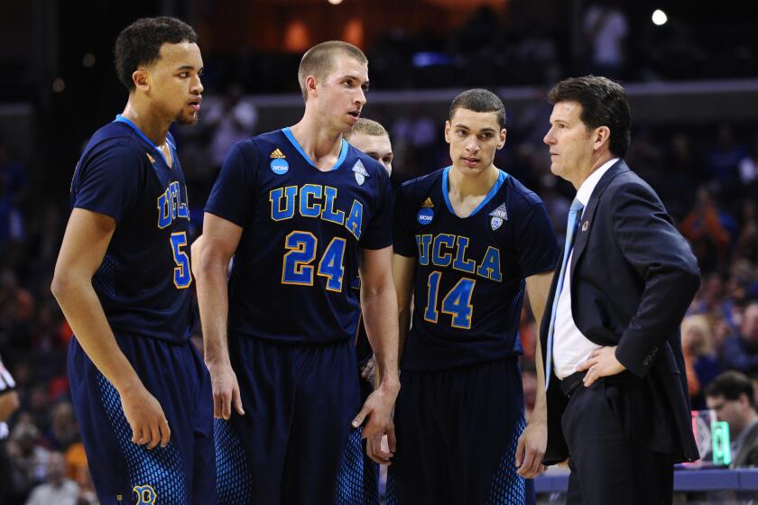 Kyle Anderson (5) and Zach LaVine (14), shown conferring on the sideline this past season with teammate Travis Wear (24) and Coach Steve Alford, won't be wearing UCLA uniforms next season.