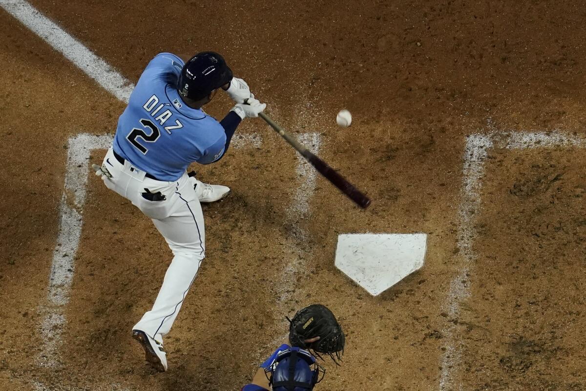 Tampa Bay's Yandy Diaz hits a run-scoring triple in the third inning of Game 5 against the Dodgers.