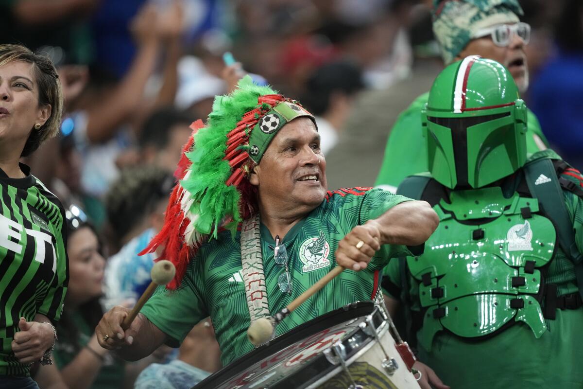 Mexico fans cheer as their team warms up before a