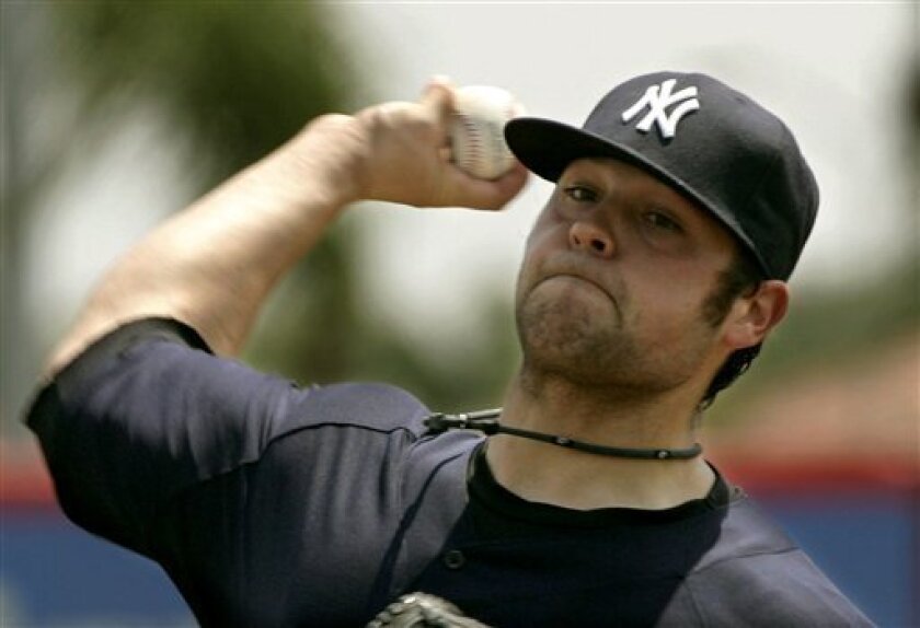 New York Yankees' Joba Chamberlain throws one of his warmup pitches against the Cincinnati Reds in the spring training baseball game in Sarasota, Fla., Tuesday, March 31, 2009. (AP Photo/Keith Srakocic)