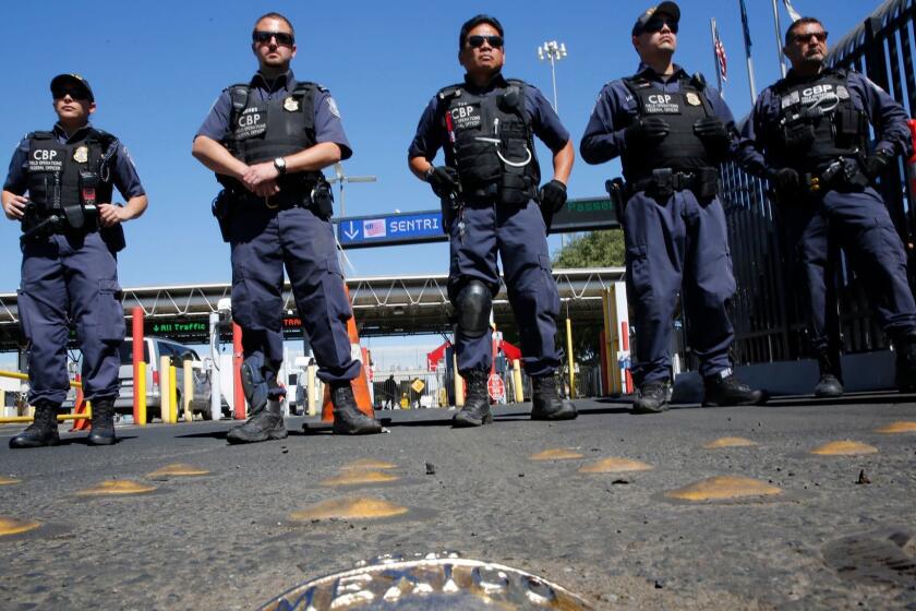 MARCH 10, 2014. TIJUANA, MEXICO. United States Customs and Border Protection officers span the northbound approach to the Otay Mesa Port of Entry from Tijuana, Mexico, during a rally and march by the National Immigrant Youth Alliance on March 10, 2014. Scores of Mexican citizen students and families who were deported from the U.S. planned to cross the border and apply for legal entry documents. No arrests or disturbances were reported. (Don Bartletti / Los Angeles Times)