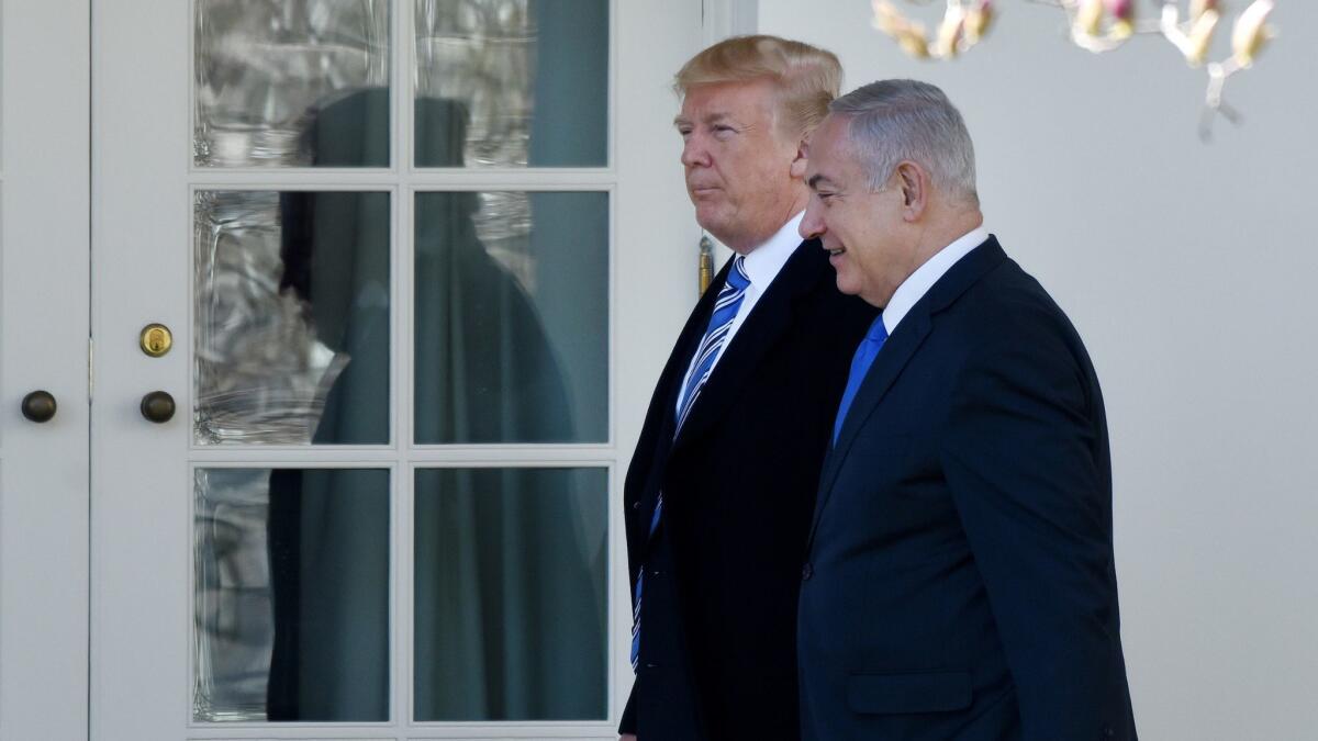 President Trump and Israel Prime Minister Benjamin Netanyahu walk outside the White House in March. Their closeness seems to have bolstered Netanyahu's confidence.