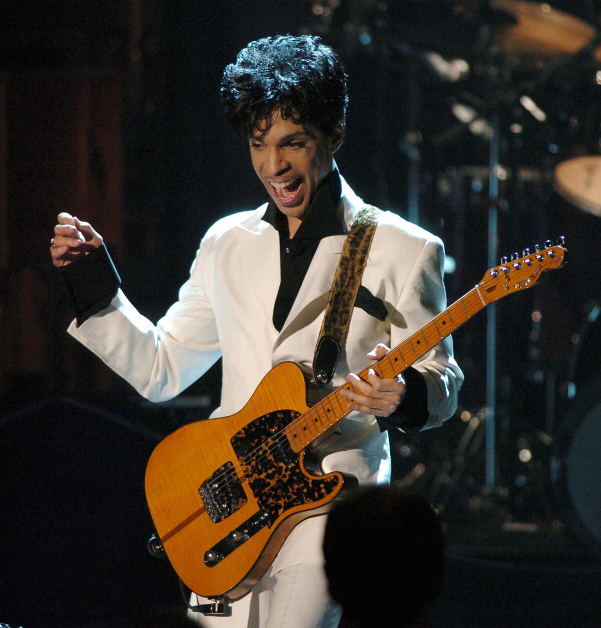 Prince performs on March 15, 2004, at the Waldorf Astoria Hotel in New York after being inducted into the Rock and Roll Hall of Fame.