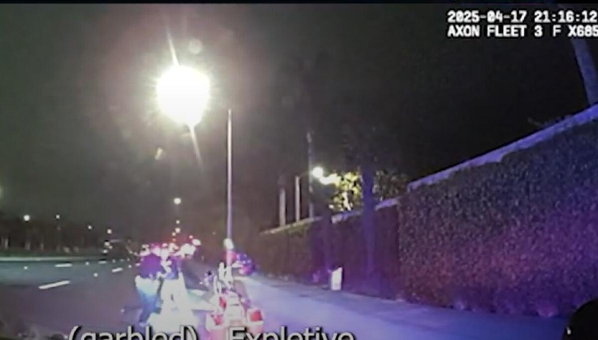 A Newport Beach police officer attempts to restrain Geoffrey Stirling on April 17.