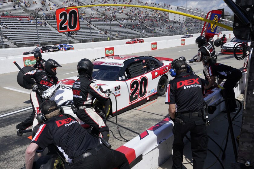 Harrison Burton (20) gets service in the pits during of the rain delayed NASCAR Xfinity Series auto race at Martinsville Speedway in Martinsville, Va., Sunday, April 11, 2021. (AP Photo/Steve Helber)