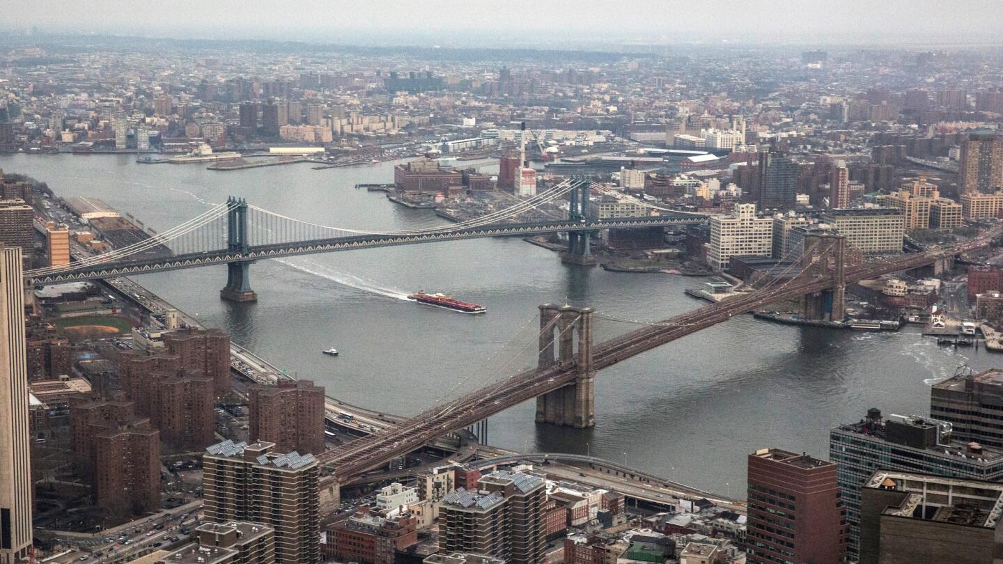 The Manhattan Bridge, left, and Brooklyn Bridge span New York's East River, as seen from Four World Trade Center on April 3, 2014.