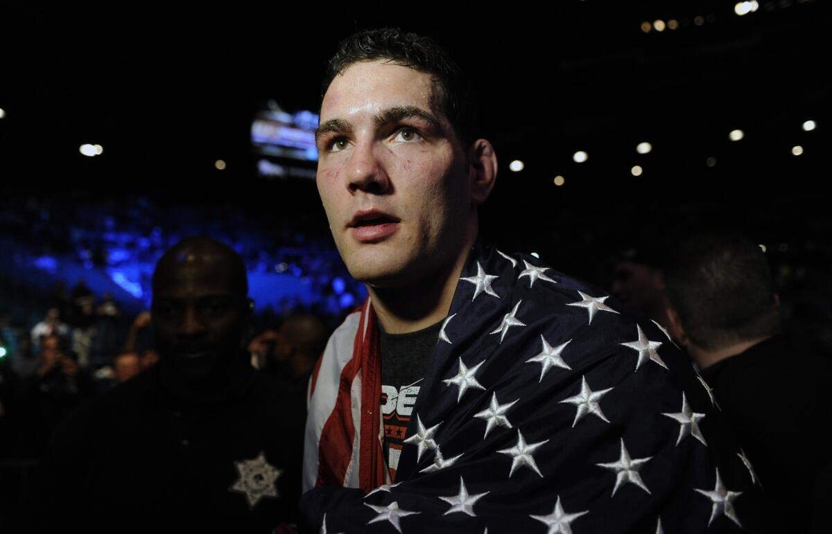 Chris Weidman celebrates with the U.S. flag draped over his shoulders after defeating Anderson Silva by technical knockout to retain his middleweight title at UFC 168 in Las Vegas on Saturday.
