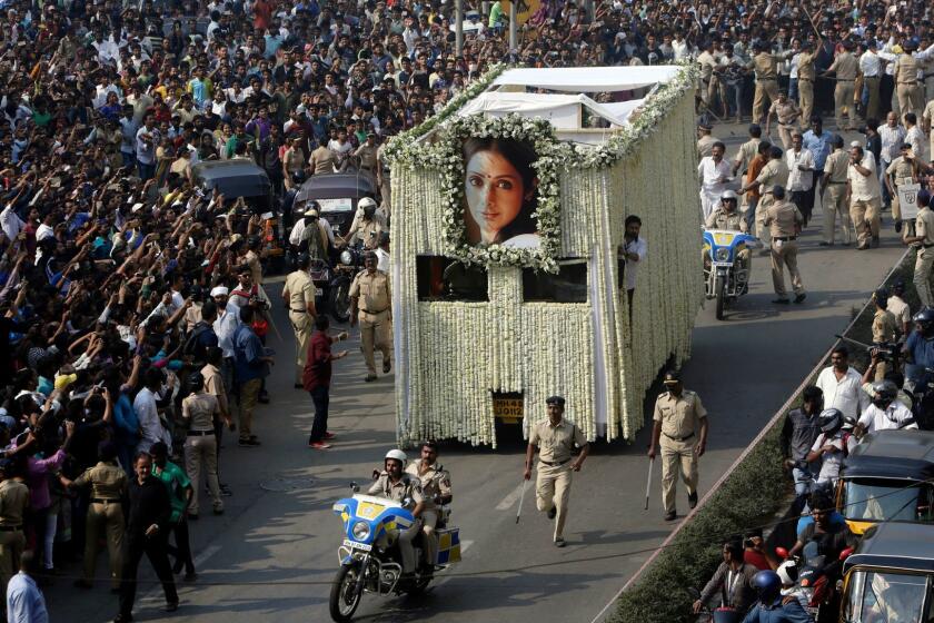 The body of Indian actress Sridevi is carried in truck during her funeral in Mumbai, India, Wednesday, Feb. 28, 2018. Lining up for hours and visibly grief-stricken, thousands of mourning fans paid their respects Wednesday to Sridevi, the iconic Bollywood actress who drowned accidentally in a Dubai hotel bathtub over the weekend. (AP Photo/Rajanish Kakade)