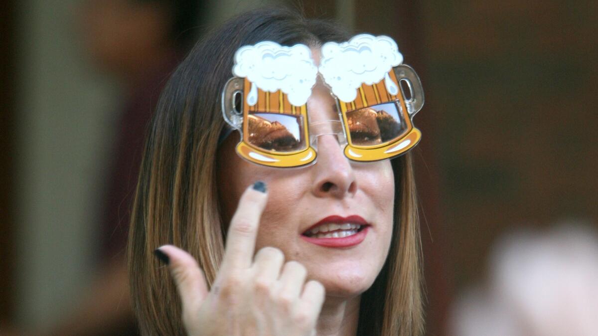 Verenice Salazar of San Dimas dons a pair of beer goggles at the Burbank Beer Festival, in this file photo taken on Saturday, Oct. 17, 2015.