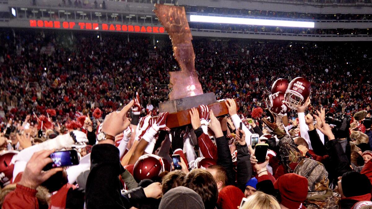 Arkansas players and fans celebrate with "The Boot" trophy after the Razorbacks' 17-0 victory over LSU on Saturday.