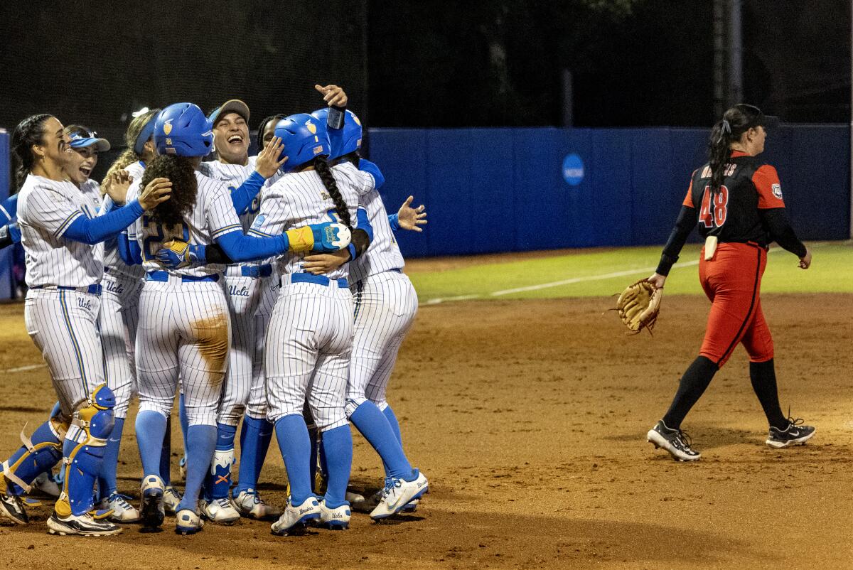 UCLA players celebrate after defeating Georgia 8-0 in the NCAA Super Regionals on