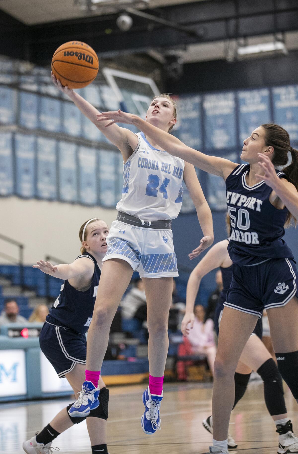 Corona del Mar's Dorothy Schwenck goes up for a layup against Newport Harbor's Maile Akana in the Battle of the Bay game.