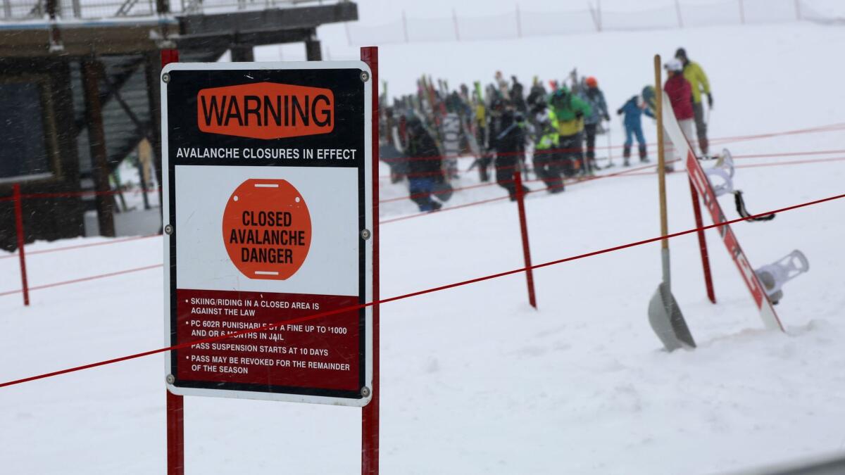 A sign at the Broadway Express chairlift informs visitors that the Mammoth Mountain ski area is closed after Saturday morning's avalanche.