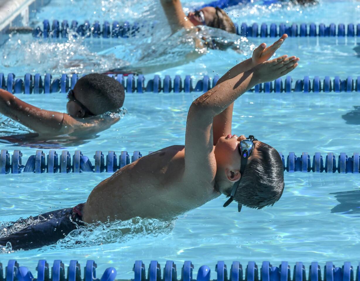Harpers Choice's Cole Portz pushes away from the wall during his heat of the 7-8 boys 25 yard back stroke during the Columbia Neighborhood Swim League meet between host Clemens Crossing and Harper's Choice Saturday morning in Columbia.