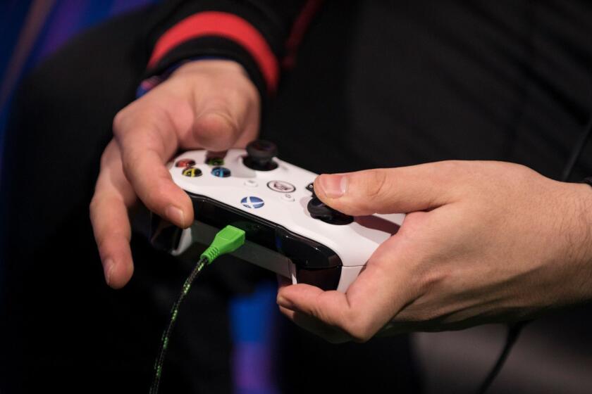 Mandatory Credit: Photo by JULIEN DE ROSA/EPA-EFE/REX/Shutterstock (9685810i) A competitior holds a xBox controller during a qualifiers match in the FIFA 18 video game, at the eSports tournament FIFA eClub World Cup 2018 near Paris, France, 19 May 2018. Sixteen professional eSports football teams compete in the qualifiers for entering the EA SPORTS FIFA 18 Global Series Playoffs. FIFA eClub World Cup, Saint Denis, France - 19 May 2018 ** Usable by LA, CT and MoD ONLY **