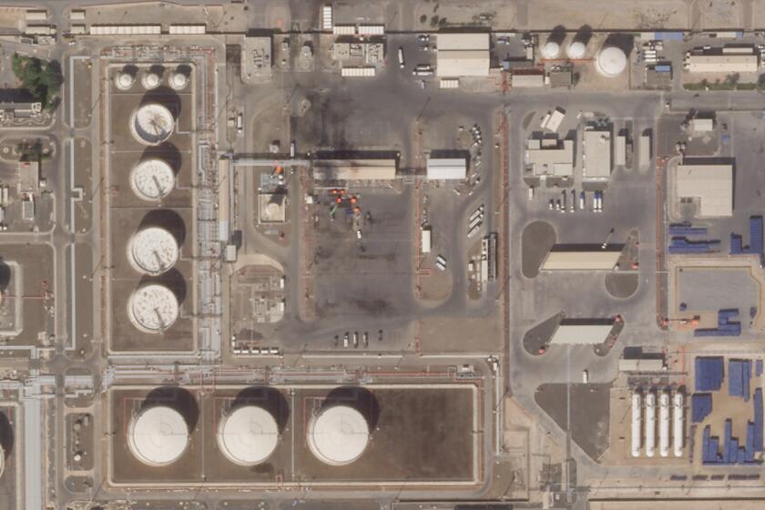 This satellite image provided Planet Labs PBC shows the aftermath of an attack claimed by Yemen's Houthi rebels on an Abu Dhabi National Oil Co. fuel depot in the Mussafah neighborhood of Abu Dhabi, United Arab Emirates, Saturday, Jan. 22, 2022. The United Arab Emirates intercepted two ballistic missiles targeting Abu Dhabi in a new attack early Monday, Jan. 24, 2022, its state-run news agency reported, the latest attack to target the Emirati capital. No group immediately claimed responsibility but suspicion immediately fell on the Houthis. (Planet Labs PBC via AP)