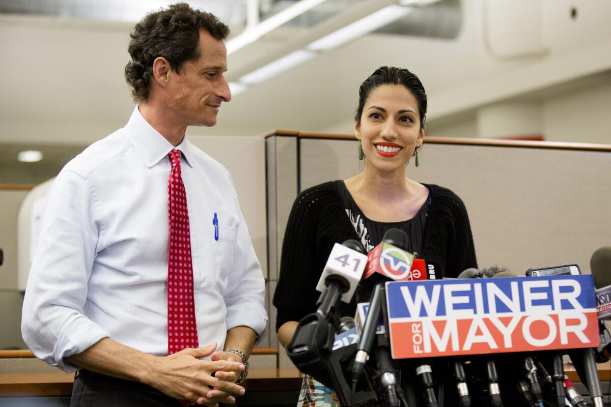 Huma Abedin, alongside her husband, New York mayoral candidate Anthony Weiner, speaks during a news conference Tuesday in New York.