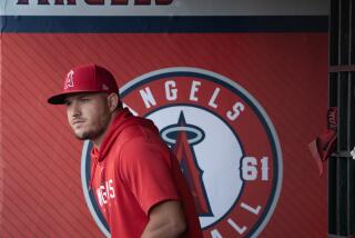 Angels star Mike Trout walks in the dugout before a game with the Yankees at Angel Stadium.