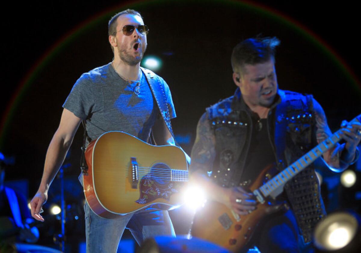 Eric Church, left, performs Friday night at the Stagecoach Country Music Festival in Indio.