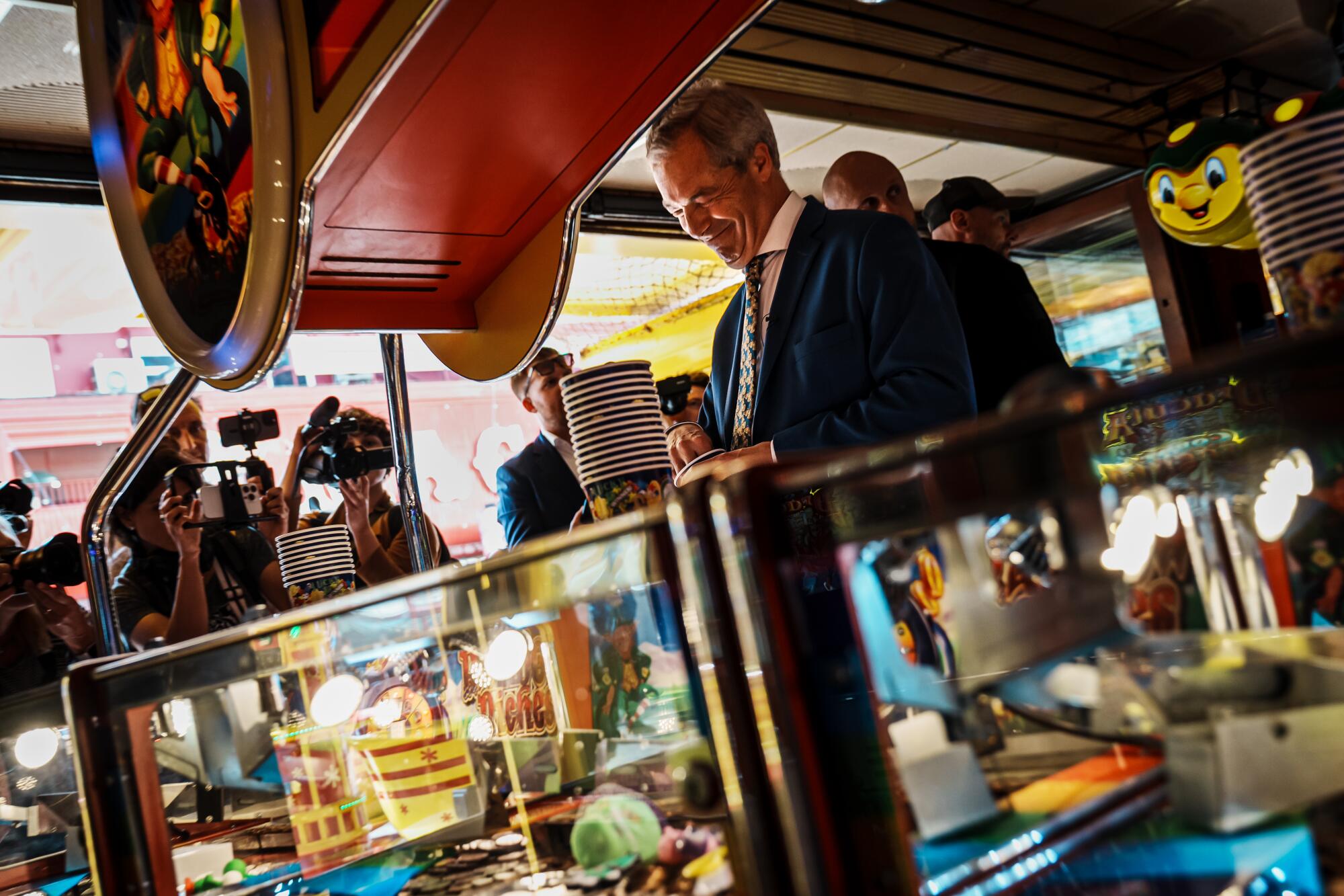 Nigel Farage reacts to playing a game at an amusement arcade.