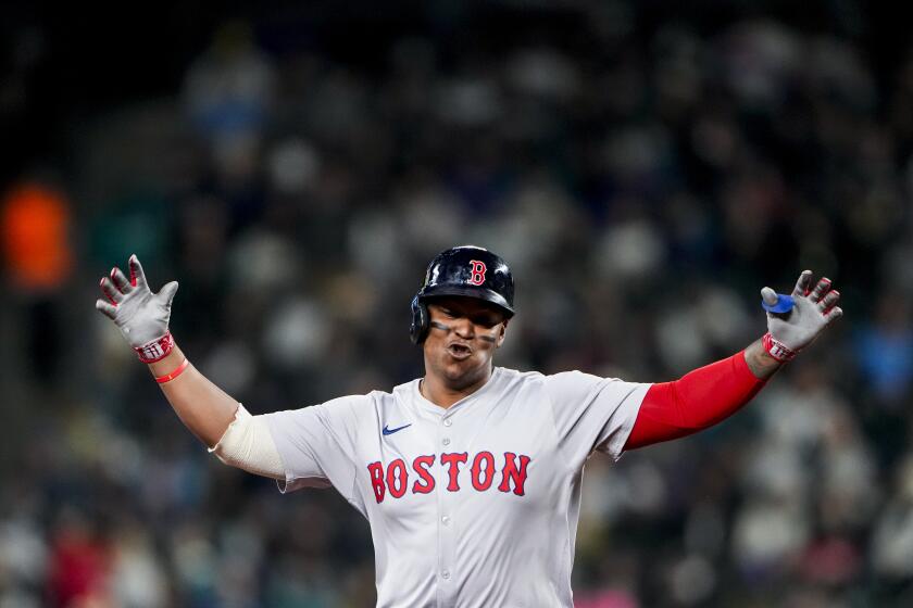 Boston Red Sox's Rafael Devers gestures while running the bases on a two-run home run against the Seattle Mariners during the third inning of an opening-day baseball game Thursday, March 28, 2024, in Seattle. (AP Photo/Lindsey Wasson)
