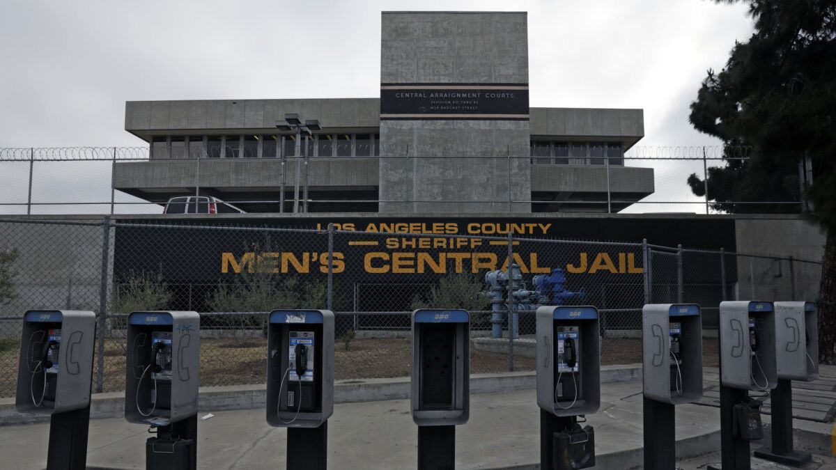 Phone booths line the street near Men's Central Jail in downtown Los Angeles. The L.A. County Board of Supervisors voted Tuesday to approve $2.2 billion to replace the jail with a "correctional treatment facility" aimed at serving mentally and medically ill inmates.