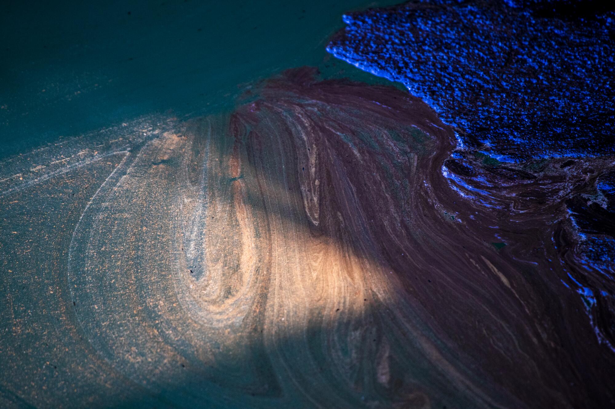 Detail of oil flowing through the Talbert Channel in Orange County.