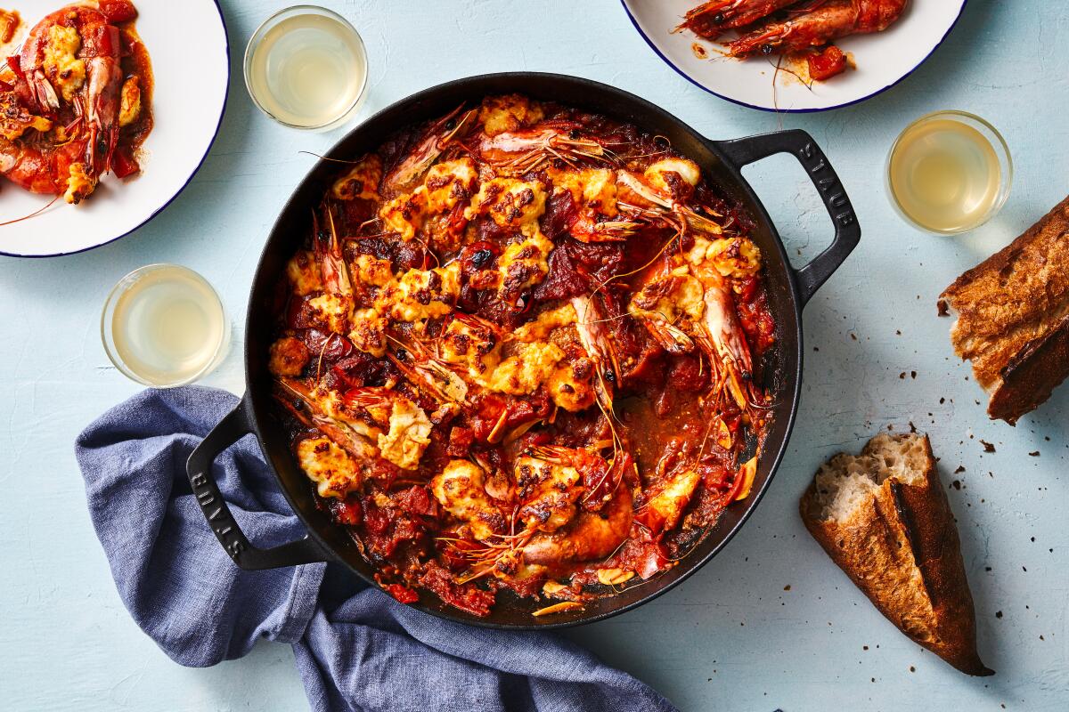 Harissa-spiced tomato sauce suffuses sweet shrimp in this take on classic Greek shrimp saganaki, topped with crisp bits of halloumi. Prop styling by Nidia Cueva.