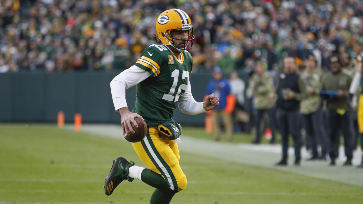 Green Bay Packers' Aaron Rodgers runs during the first half against the Seattle Seahawks.