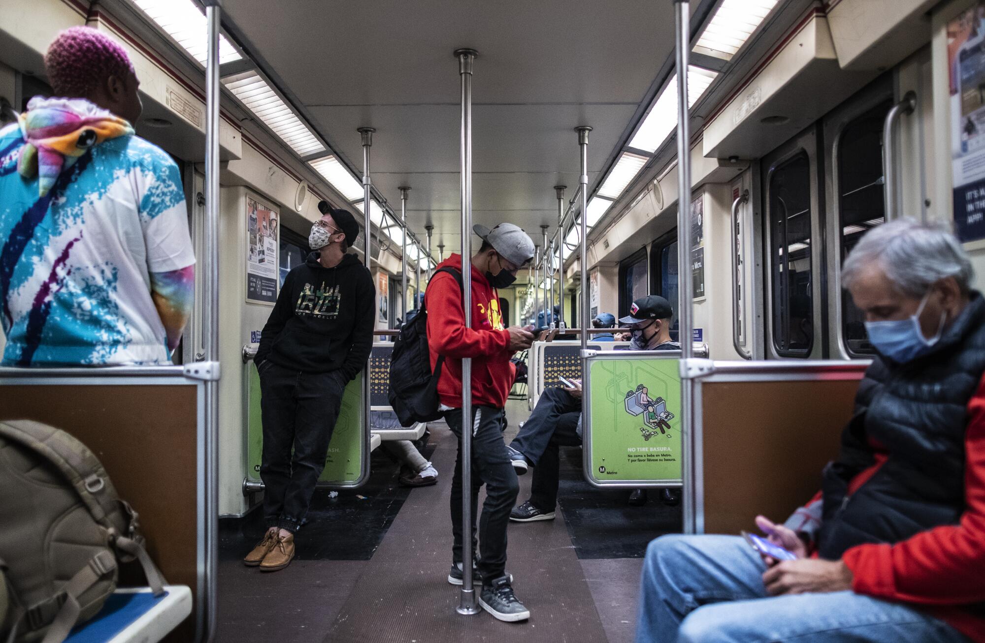 Subway riders on the Metro Red Line on Nov. 16