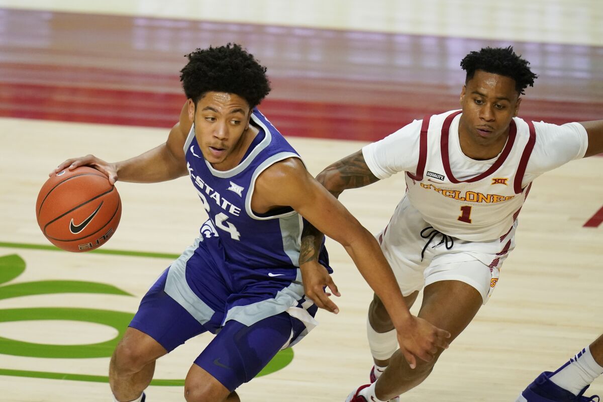 Kansas State guard Nijel Pack drives around Iowa State guard Tyler Harris, right, during the first half of an NCAA college basketball game, Tuesday, Dec. 15, 2020, in Ames, Iowa. (AP Photo/Charlie Neibergall)