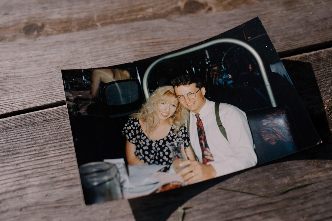 An archival photograph of Tasha Adams during her honeymoon with Stewart Rhodes rests on a table.