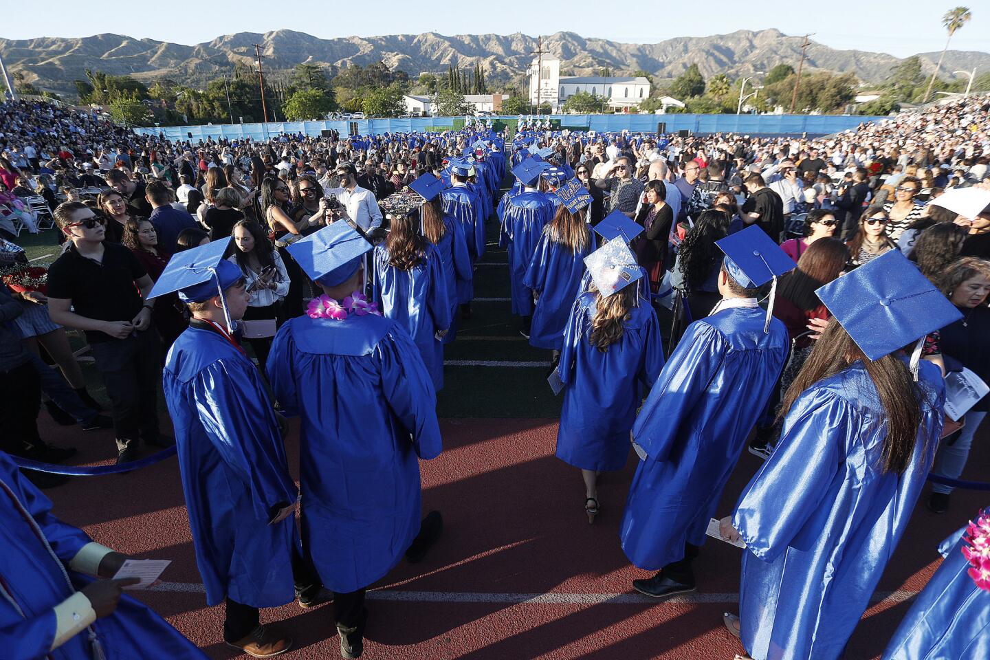 Burbank graduates file into the graduation bowl created on the football field at the graduation ceremony for Burbank High School in Burbank on Friday, May 24, 2019.
