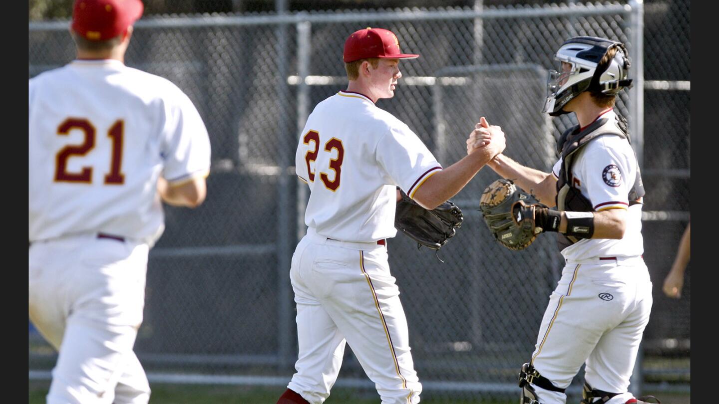 La Cañada High School pitcher #23 Ryan Graves gets a handshake from pitcher #6 Graham Massimino (C) after Graves went the distance, six and a half innings, for the win, 6-3, in CIF Southern Section Division V first round game vs. Lompoc High School at the Spartans home field in La Cañada Flintridge on Thursday, May 18, 2017.