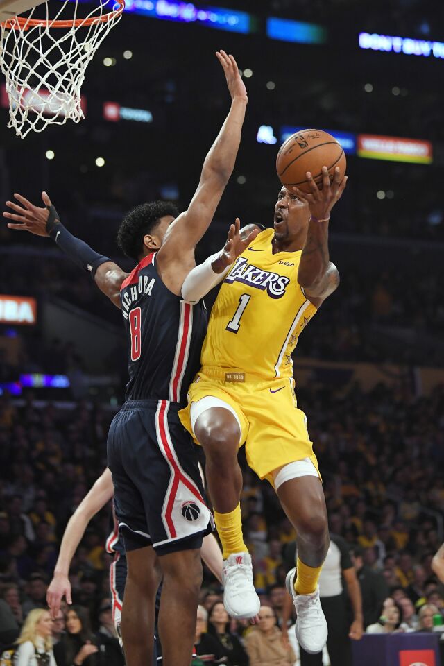 Lakers guard Kentavious Caldwell-Pope goes to the basket against Wizards forward Rui Hachimura during a game Nov. 29 at Staples Center.