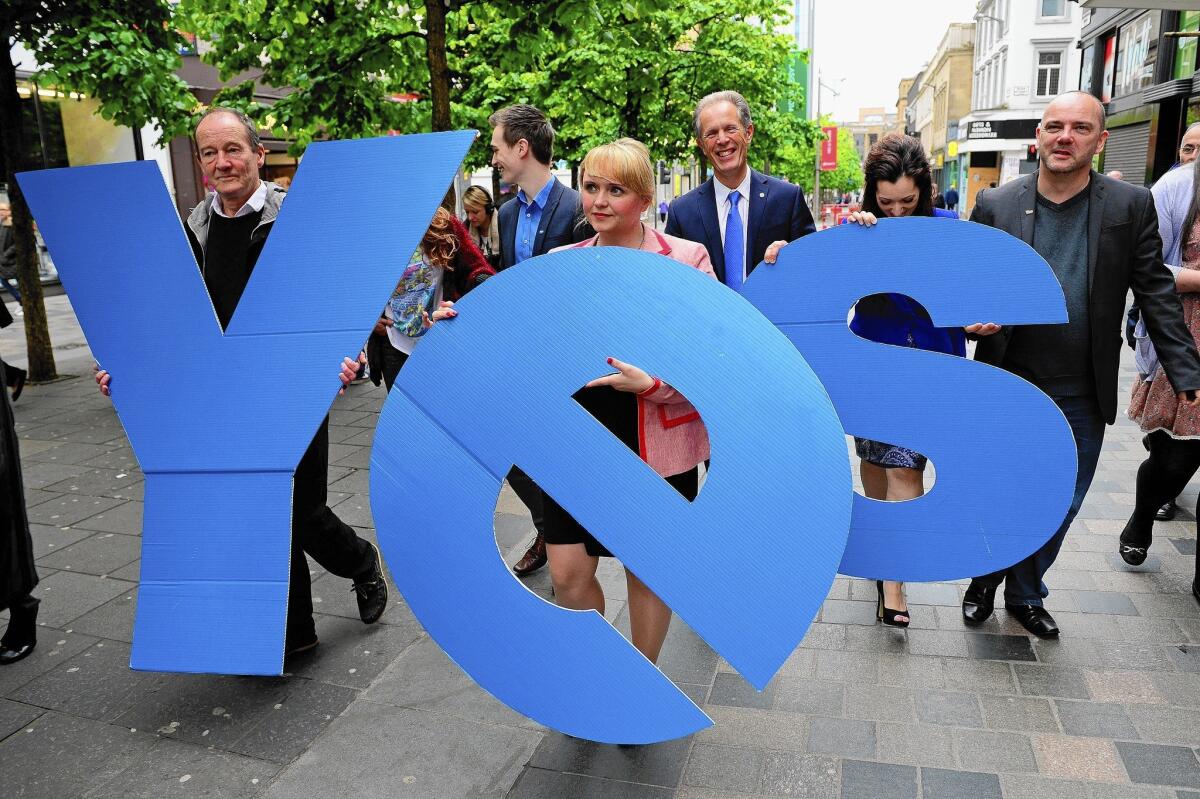 Actor David Hayman, left, and Yes Scotland Chief Executive Blair Jenkins, third from right, and other proponents of Scottish independence mark the start of the campaign period May 30 in Glasgow. Voters will cast their ballots Sept. 18.