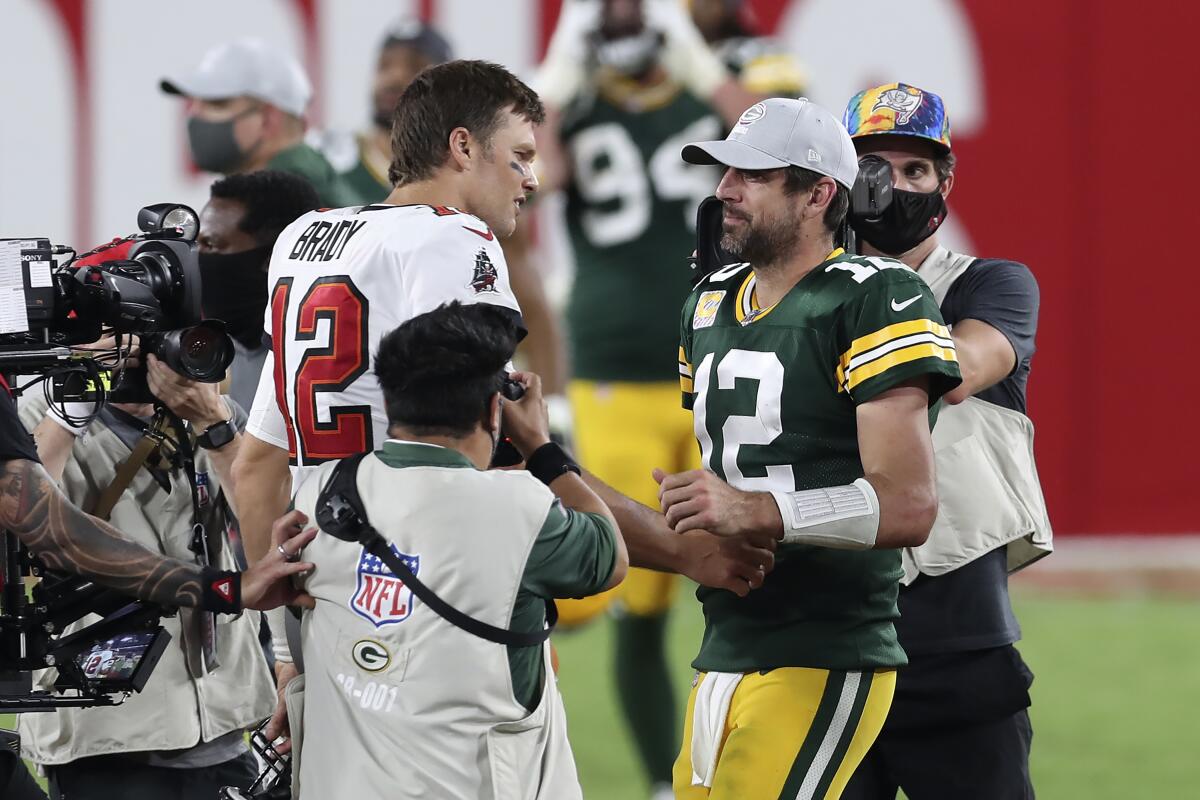 Buccaneers quarterback Tom Brady, left, shakes hands with Aaron Rodgers after Green Bay lost in Tampa in October. 