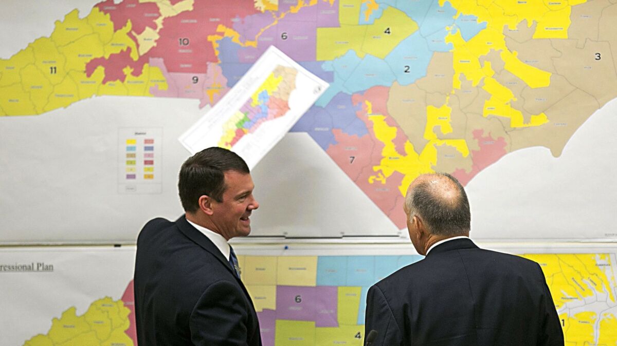 Republican state Sens. Dan Soucek, left, and Brent Jackson review maps as North Carolina's Redistricting Committee meets in Raleigh, N.C., on Feb. 16, 2016.
